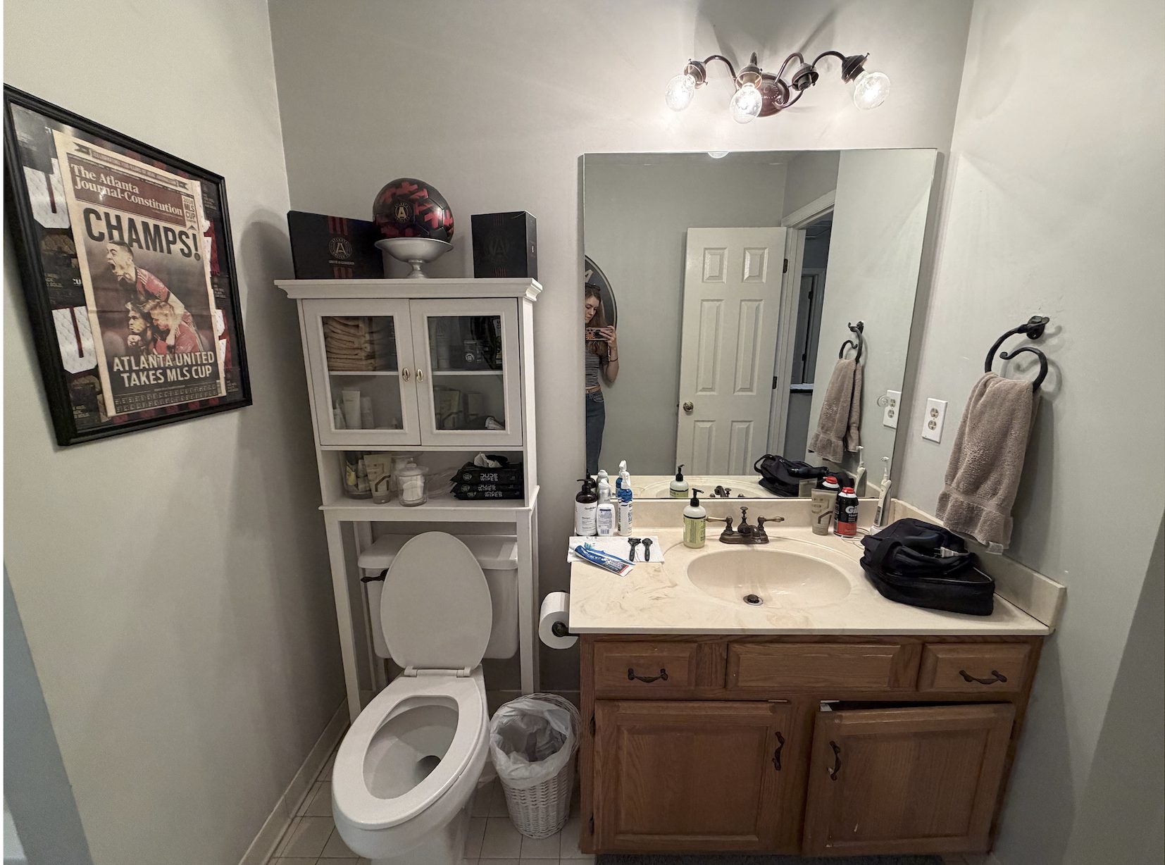 Lisa & Alex bathroom — before photo of existing vanity wall with laminate counters and oak cabinet