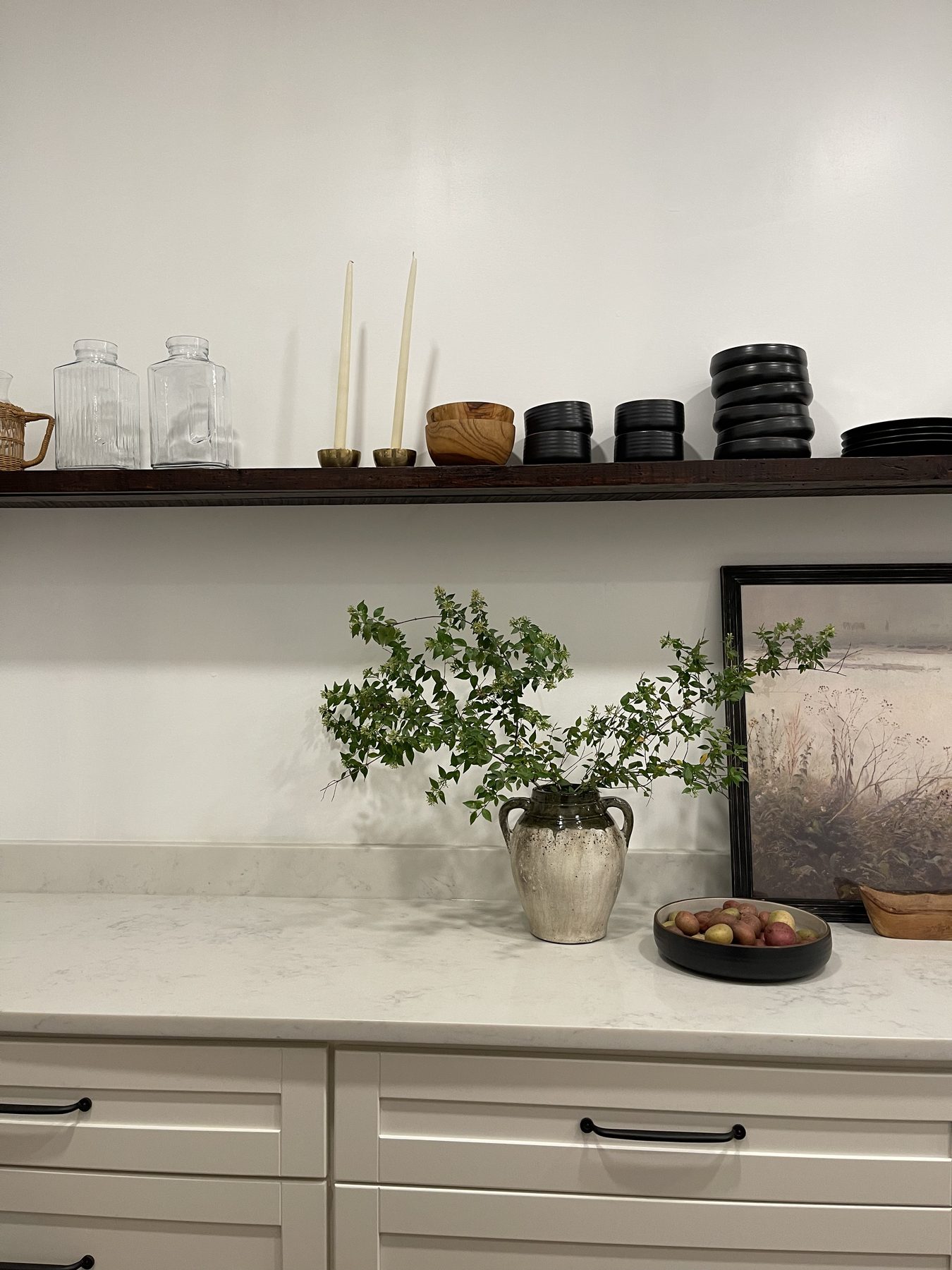 Birmingham kitchen — styled open wood shelving with candlesticks, stoneware, and framed art